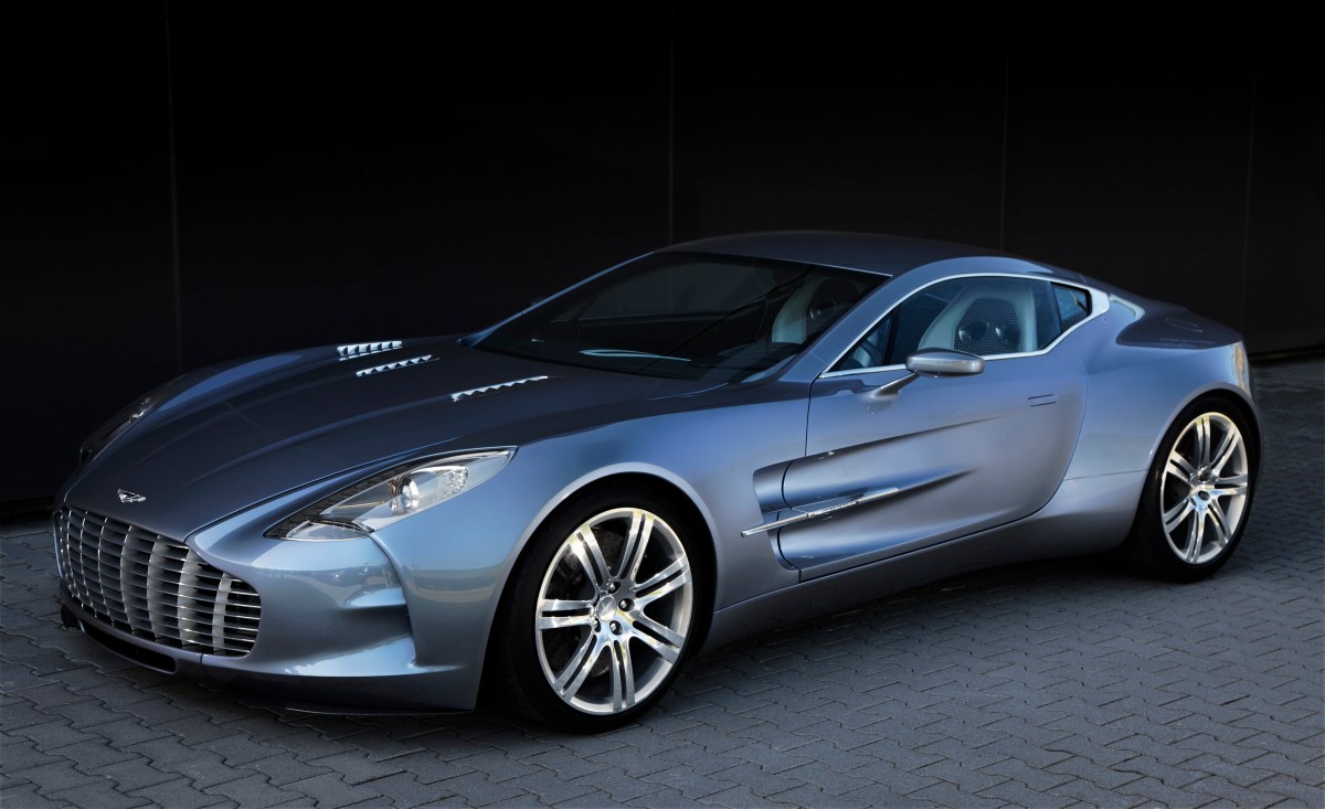 A 2010 to 2012 Aston Martin One-77 with a dark background