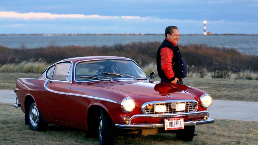 Irv Gordon Stands next to his million mile car, the 1966 Volvo P1800