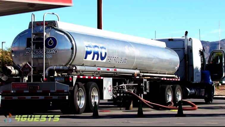 Tanker truck filling up at gas station