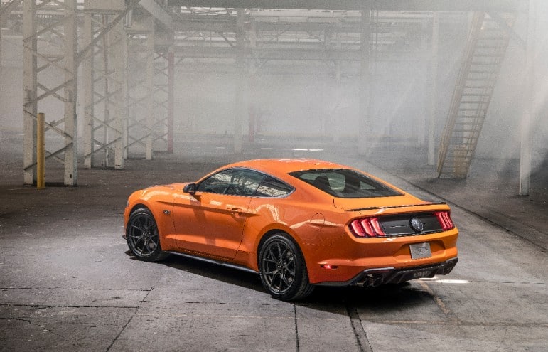 The rear view of an orange 2020 Ford Mustang EcoBoost High Performance