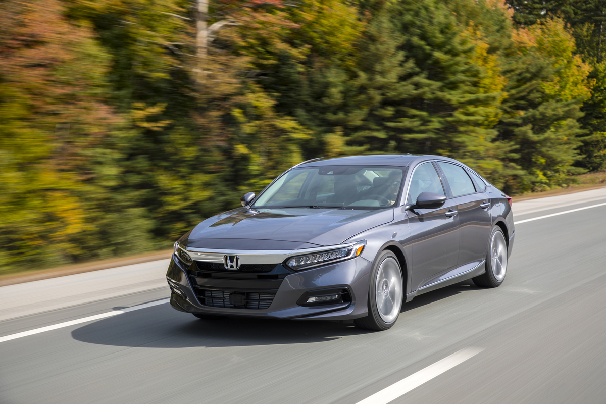 a gray Honda Accord at speed on a scenic road
