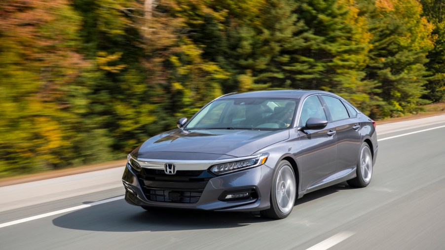 a gray Honda Accord at speed on a scenic road