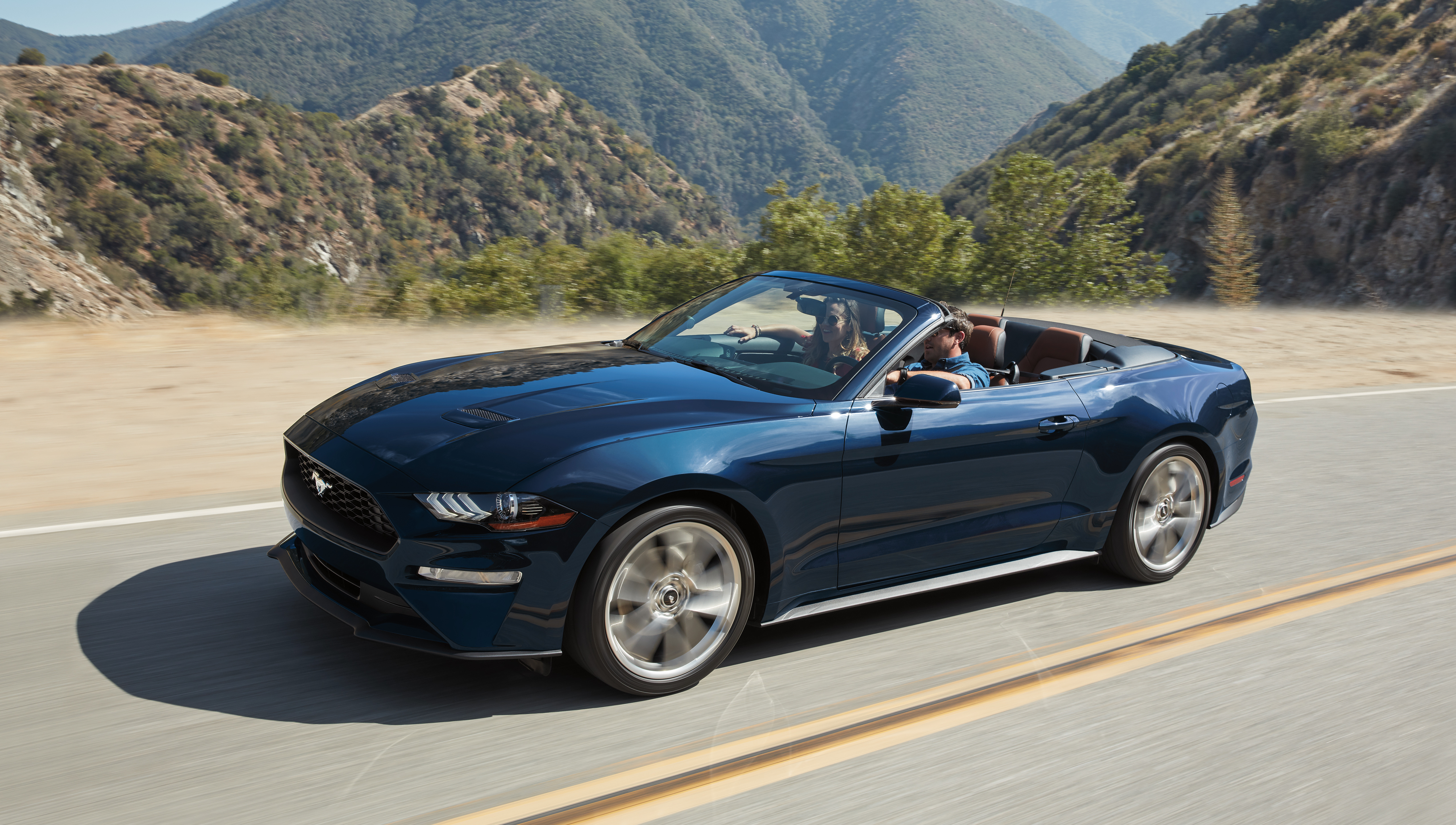 A 2019 blue Ford Mustang Ecoboost Convertible on the track.