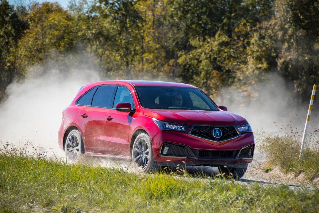 2019 Acura MDX driving down dusty road