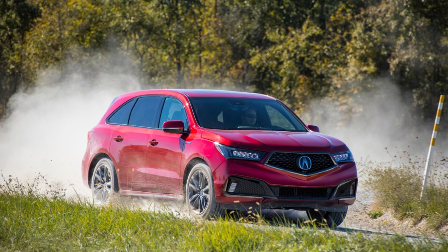 2019 Acura MDX driving down dusty road