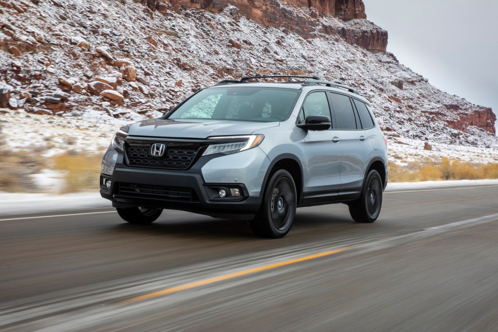 this gray 2020 Honda Passport with black wheels is racing through the mountains and looks just like Alexander Rossi's