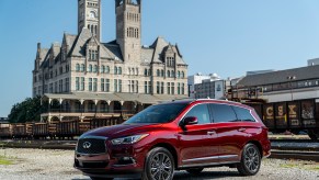 A red 2019 Infiniti QX60 Limited driving around the city.