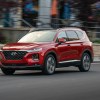 red Hyundai Santa Fe in motion down city street