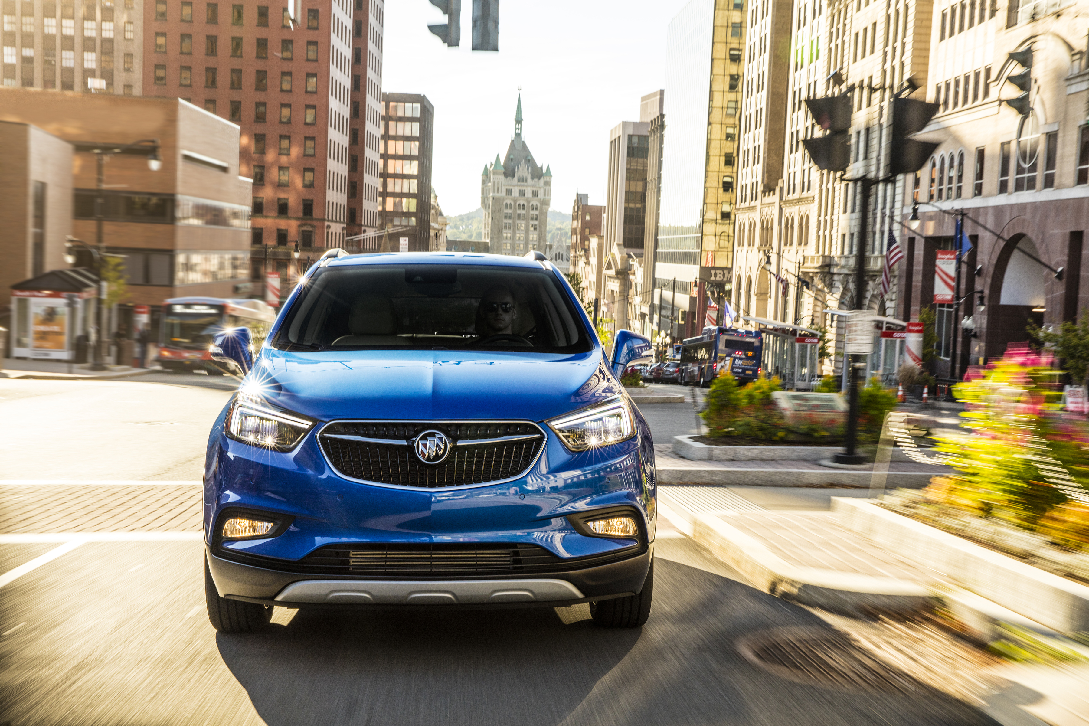 Electric Buick Encore driving through city streets.