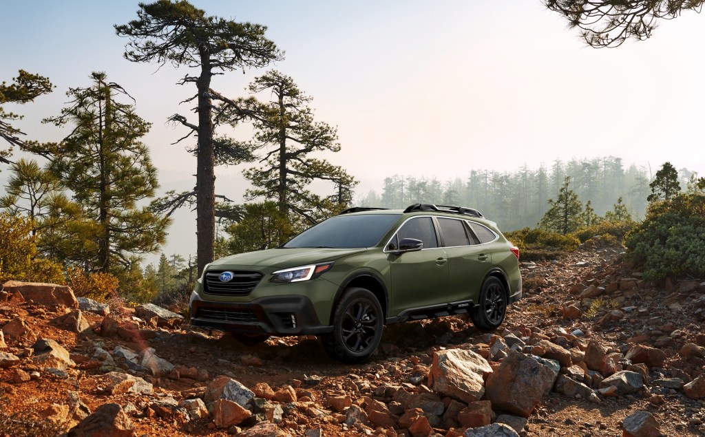 A 2020 Subaru Outback parked off-roading in a forest. 