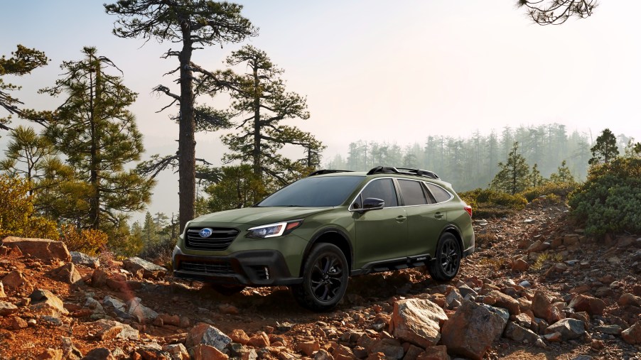 A 2020 Subaru Outback parked off-roading in a forest.
