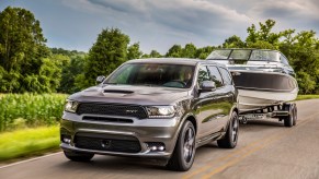 2019 Dodge Durango SRT towing a boat down a country road