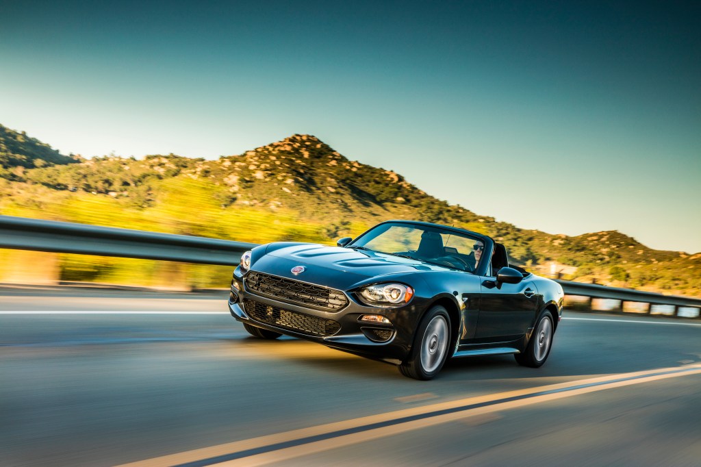 A 2019 FIAT 124 Spider driving down a desserted highway.