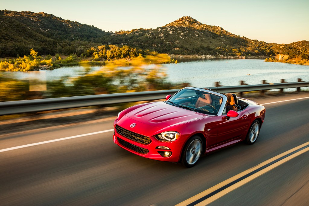 2020 Fiat 124 Spider Lusso driving down a beatufiul mountain highway.