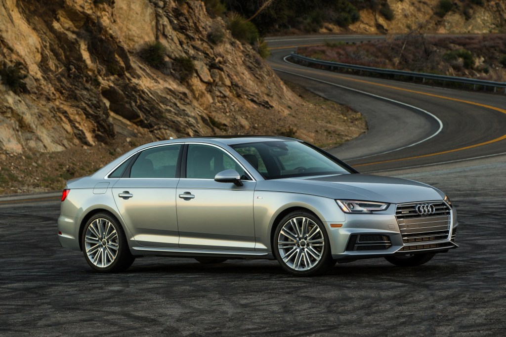 silver Audi A4 parked near a mountain road 