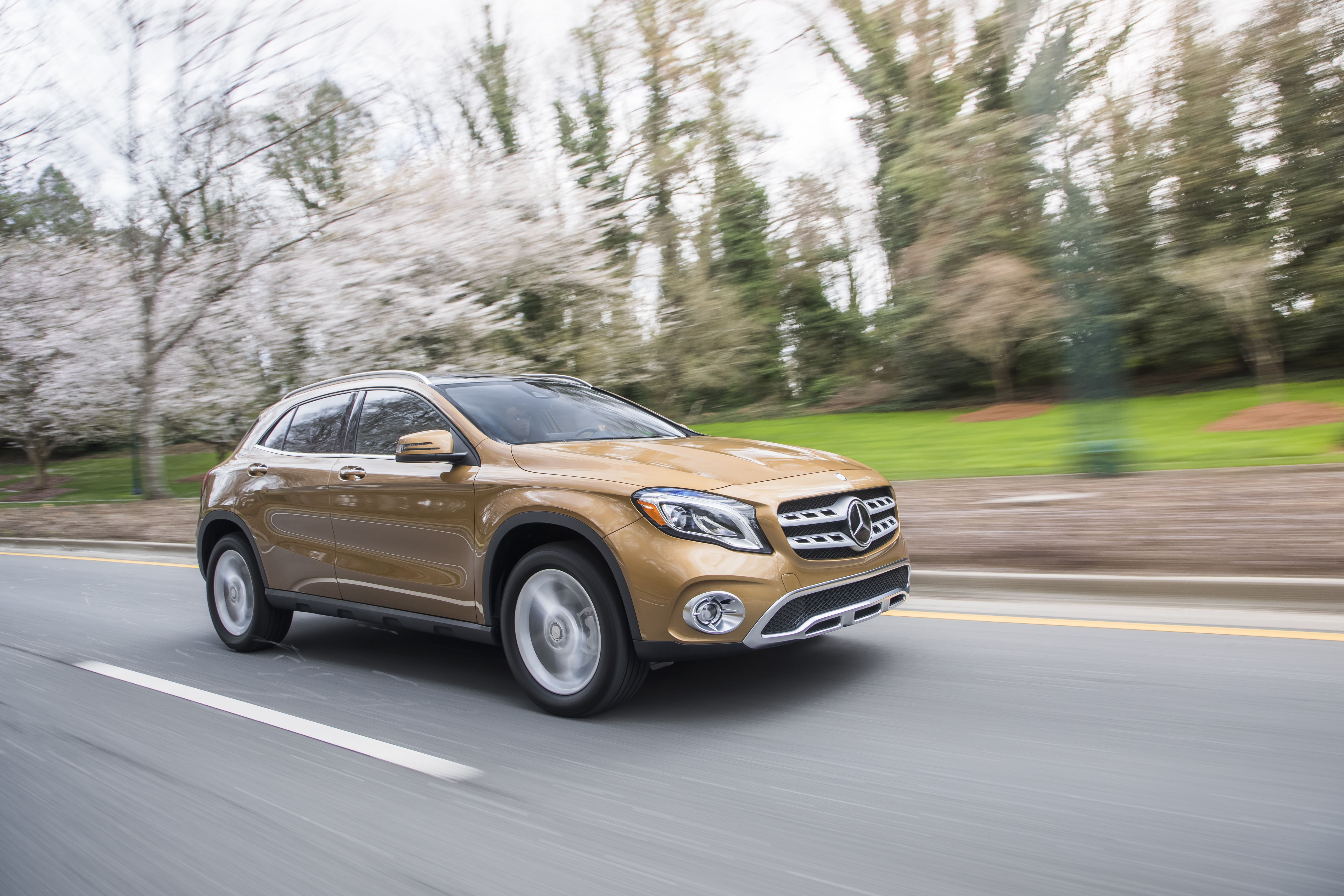 a mercedes ala crossover SUV at speed on the roadway