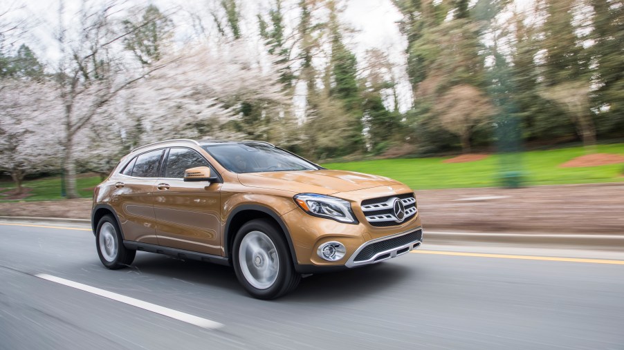 a mercedes ala crossover SUV at speed on the roadway