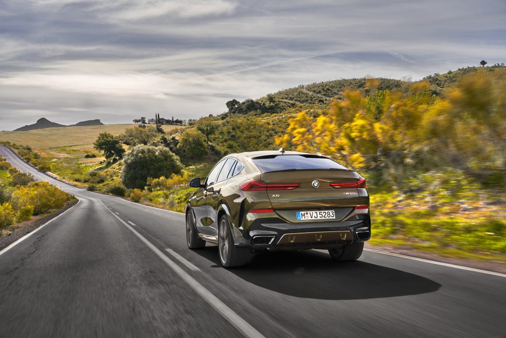 rear view of a BMW X6 driving on the road