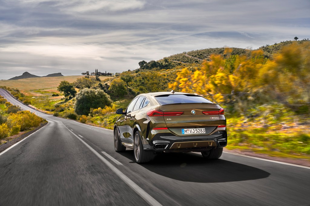 rear view of a BMW X6 driving on the road