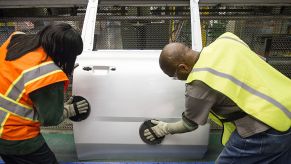 auto workers buffing car door