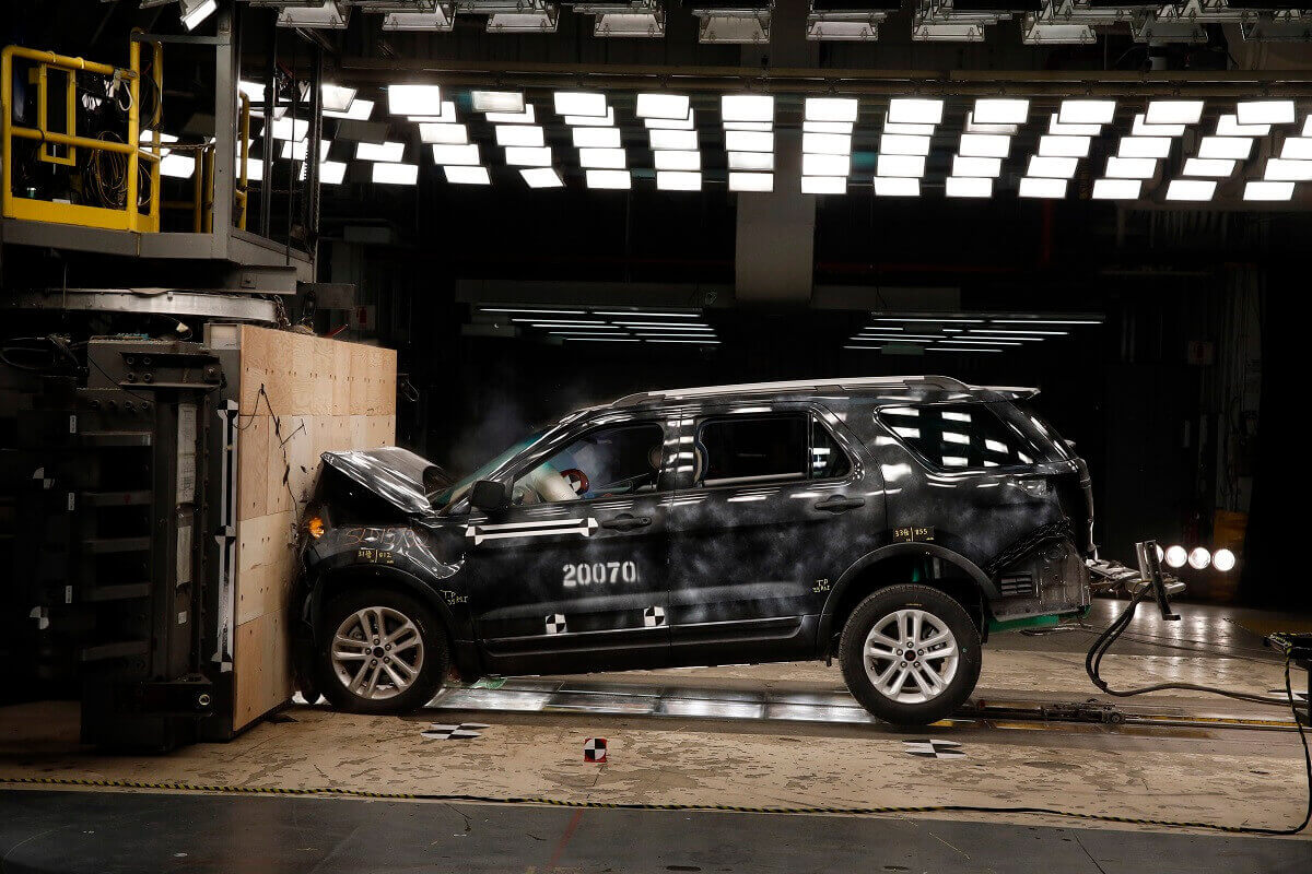 A Ford SUV slams into a wall during a crash rating test.
