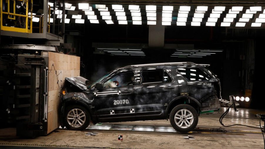 A Ford SUV slams into a wall during a crash rating test.