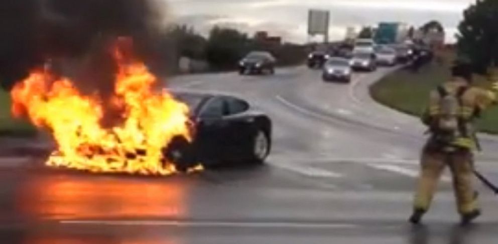 A Tesla on fire in the middle of the street