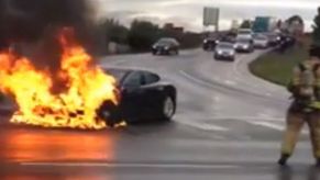 A Tesla on fire in the middle of the street
