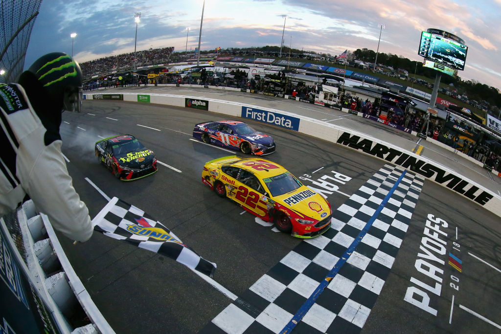 NASCAR racecars crossing the finish line.
