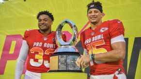Jamal Adams and Patrick Mahomes holding the 2019 Pro Bowl MVP trophy