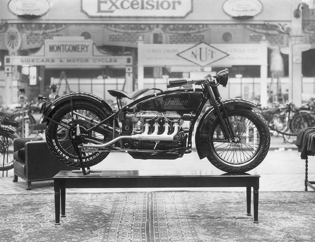 Black and white photo of the first four-cylinder Indian brand motorbike on display