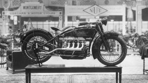 Black and white photo of the first four-cylinder Indian brand motorbike on display