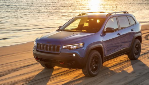 This 2020 Jeep Cherokee driving along the shore is one of the vehicles that comes equipped with a Tigershark engine