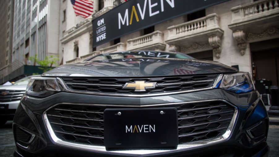 A GM Maven car-sharing service vehicle in front of the New York Stock Exchange