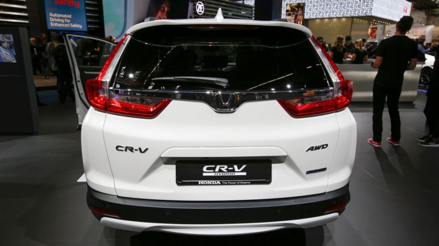 A white Hybrid Honda CR-V viewed from the back.
