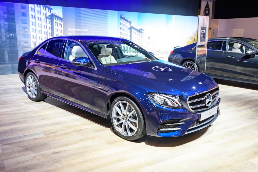 A blue Mercedes-Benz E-Class at an auto show
