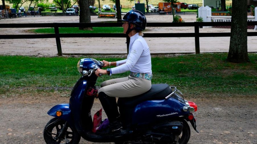 Woman riding on a moped.