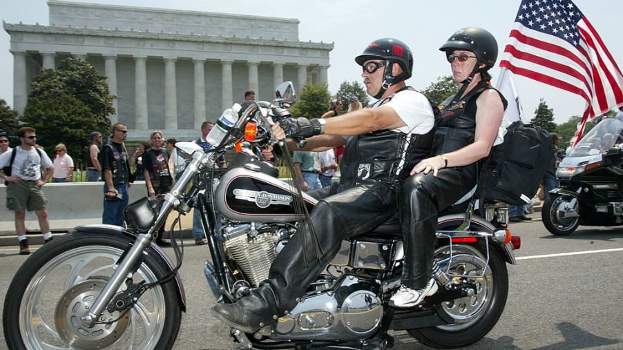 Two members of a motorcycle club taking part in a rally.