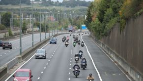 Motorcycles drive along the M1 motorway toward central London