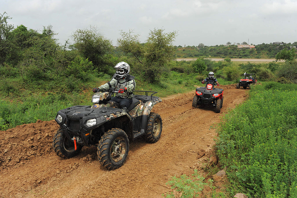 quads driving on a trail showing off their sandy ATV tires