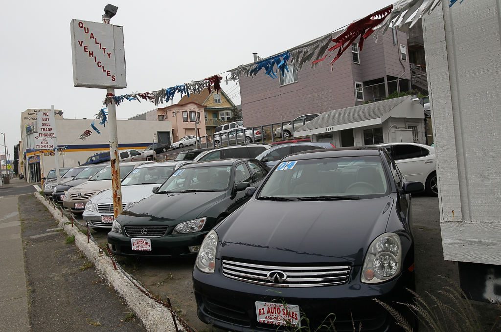 Used cars are displayed on a sales lot