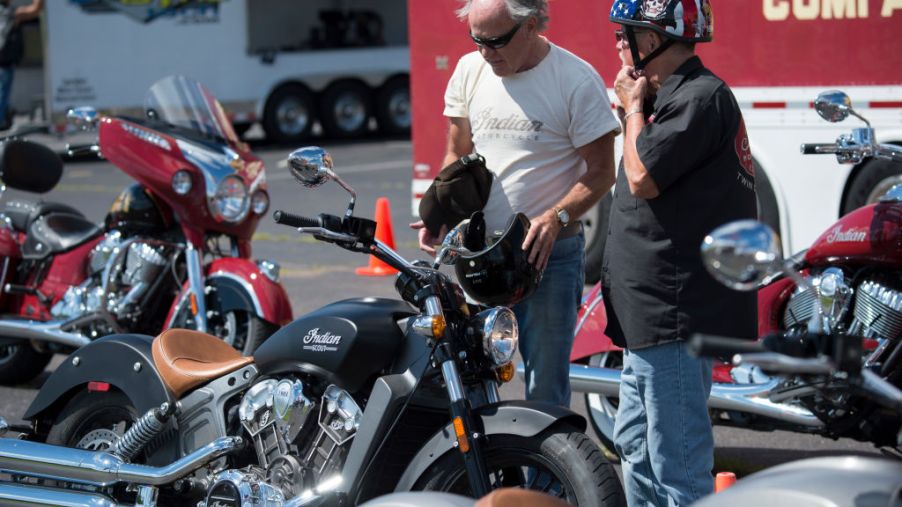 A salesman talks with a customer after a test drive on the new Indian Scout motorcycle