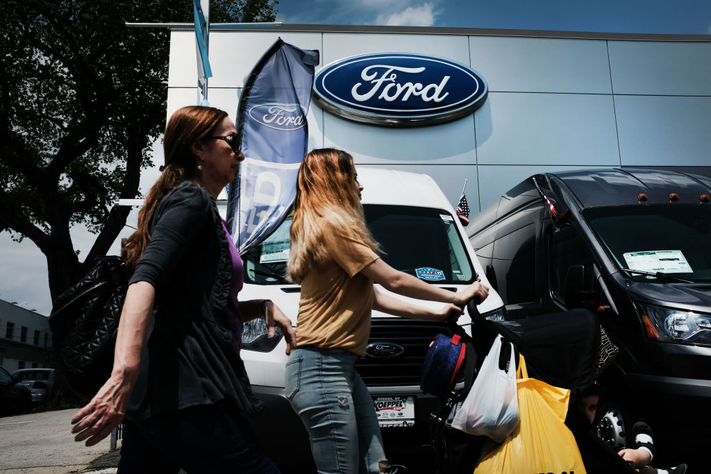 women browsing for cars at a Ford dealer