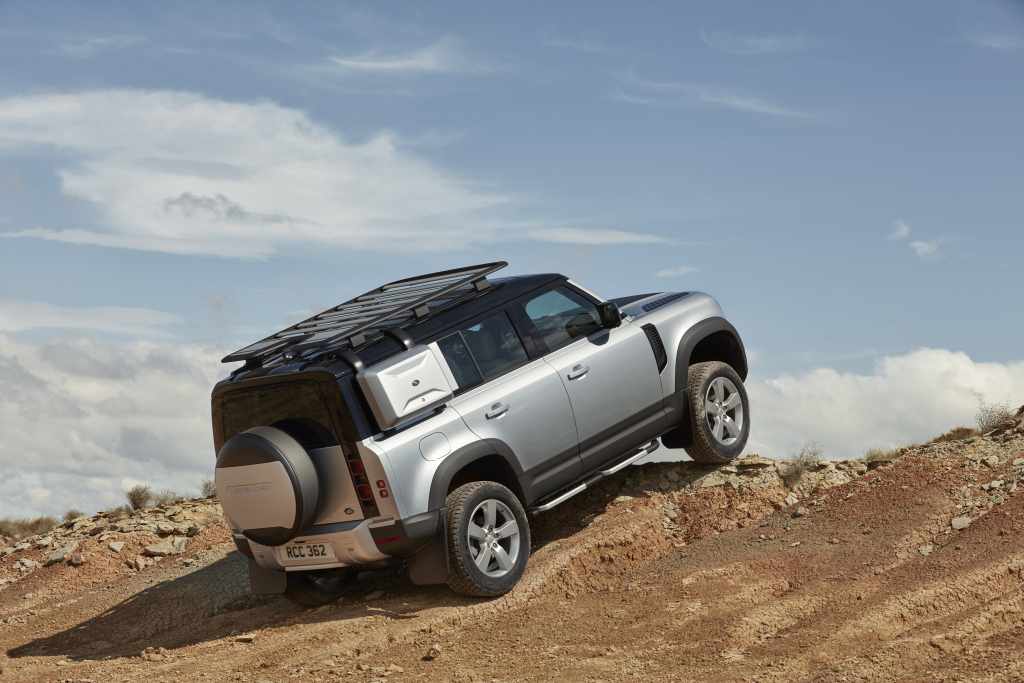 The Land Rover Defender climbing over rocks shows itself as a great alternative to an RV camper
