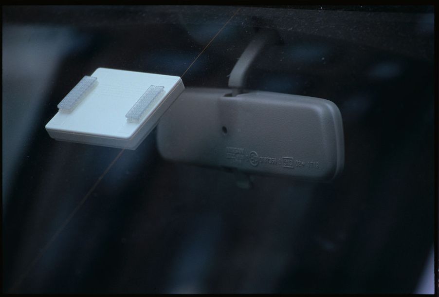 E-ZPass transponders work by passing radio frequencies to toll plazas, but they must be mounted to your car's windshield like this one