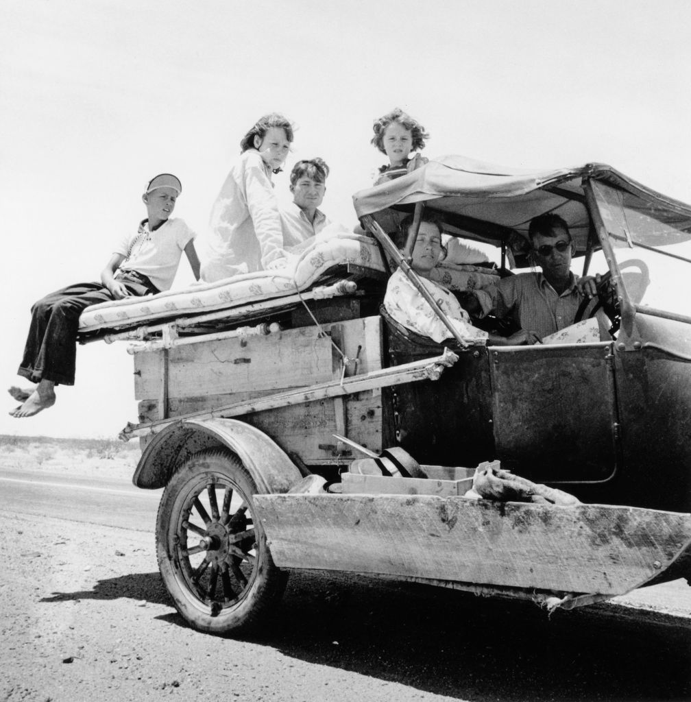 Migrant family traveling across the desert on US Highway 70, May 1937.
