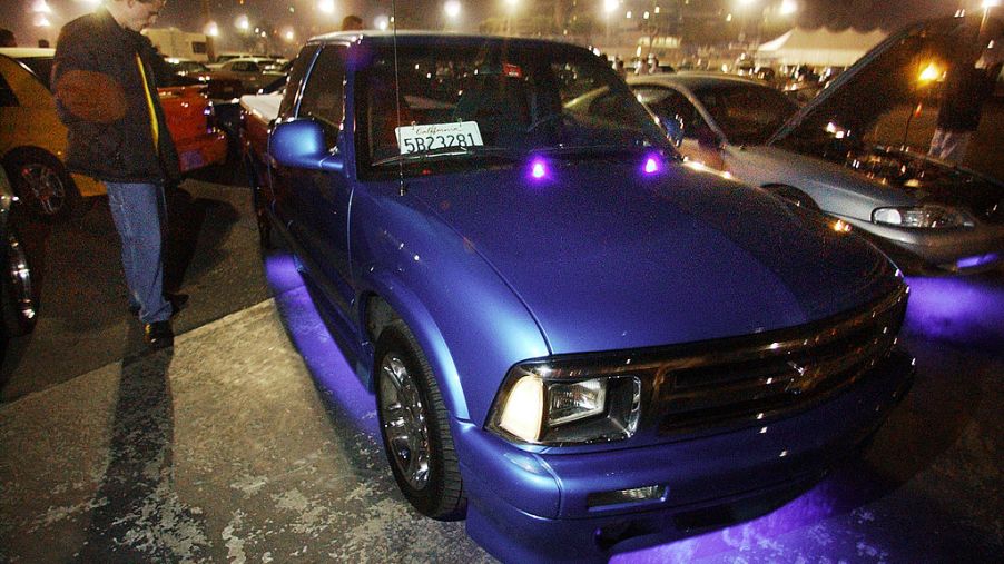 Man stands next to his modified 1995 Chevy S10