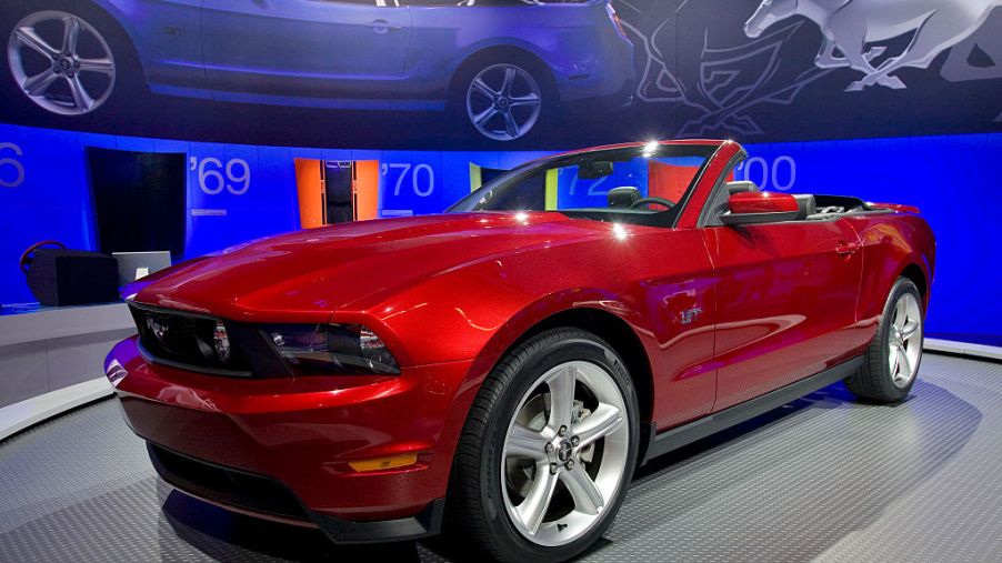 A red 2009 Ford Mustang GT on display.