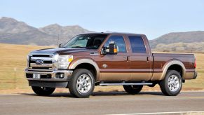 A 2011 Ford F-250 stopped on the side of a highway.