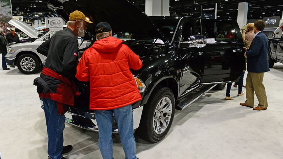 People look at the 2015 Black Dodge Ram 1500